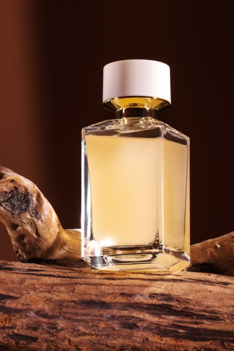 Presentation,Of,Perfume,With,Wooden,Notes,On,Brown,Background.